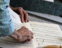 Music librarians mend aged sheet music. 